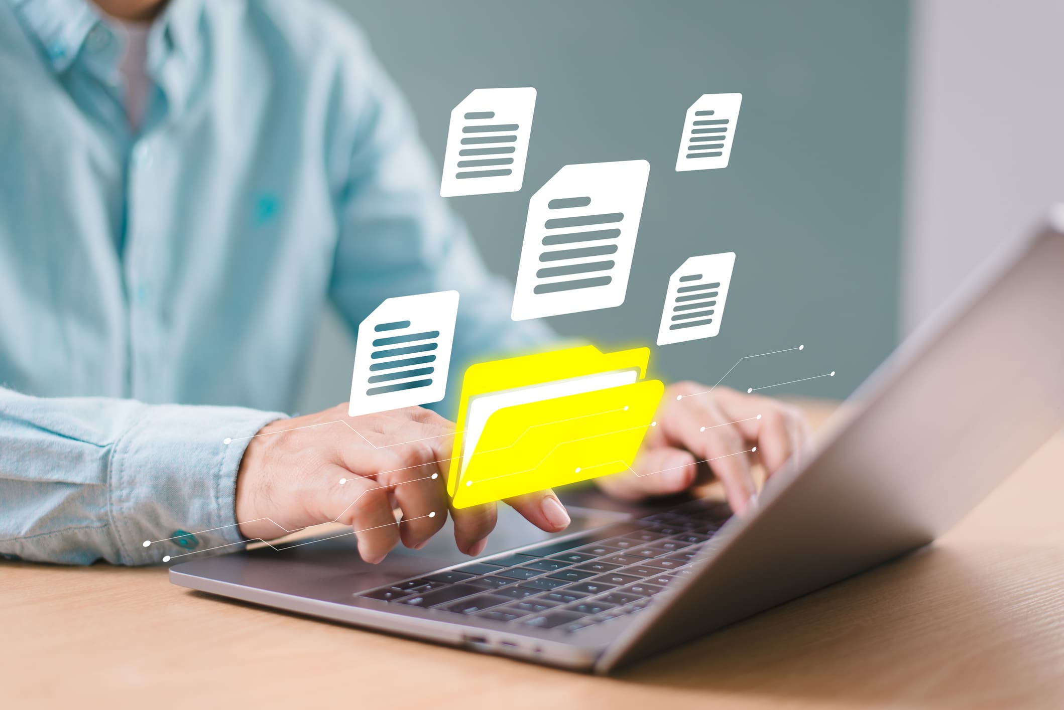 Two people exchanging digital files via a laptop.