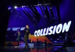 Tech conference stage with Collision sign